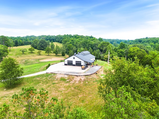 drone / aerial view featuring a view of trees