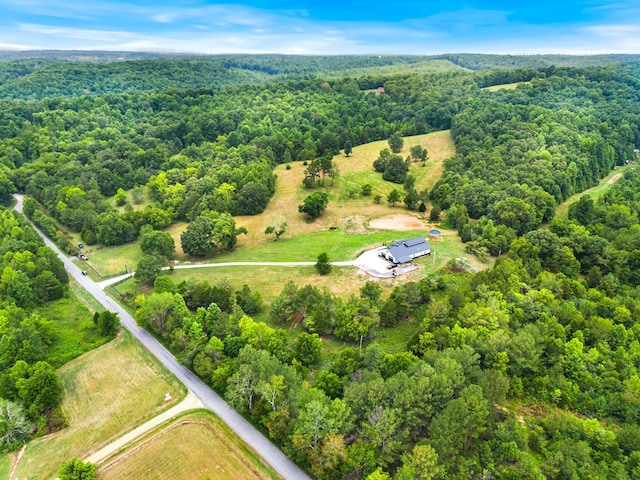 drone / aerial view featuring a forest view