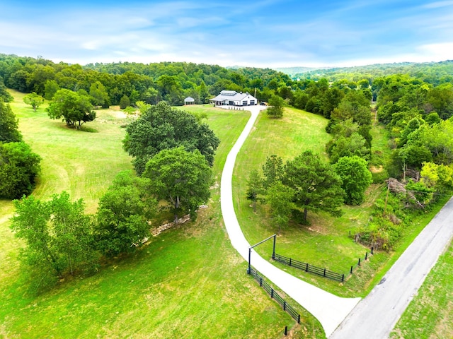 aerial view featuring a view of trees and a rural view