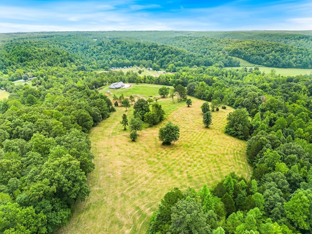 drone / aerial view with a wooded view