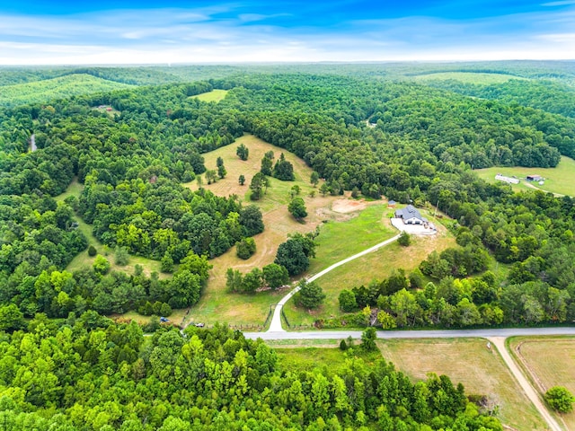 birds eye view of property with a forest view