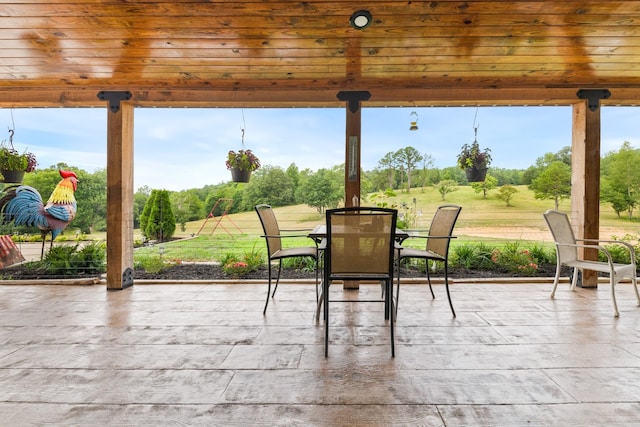 view of patio featuring outdoor dining area and a wooden deck