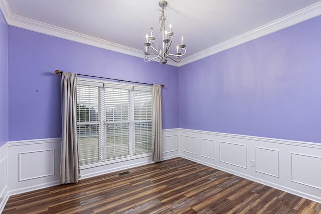 empty room featuring visible vents, dark wood-type flooring, wainscoting, crown molding, and a notable chandelier