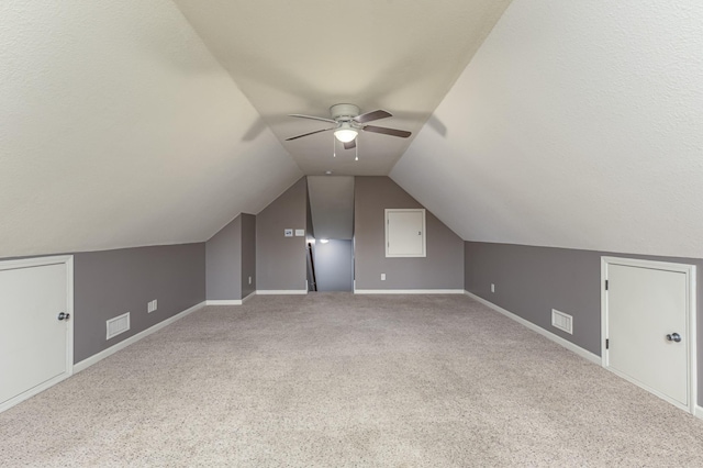 bonus room with a ceiling fan, baseboards, visible vents, vaulted ceiling, and carpet flooring