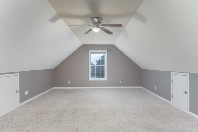 bonus room featuring carpet flooring, ceiling fan, baseboards, and lofted ceiling