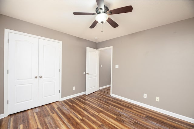 unfurnished bedroom with wood finished floors, baseboards, a closet, and ceiling fan