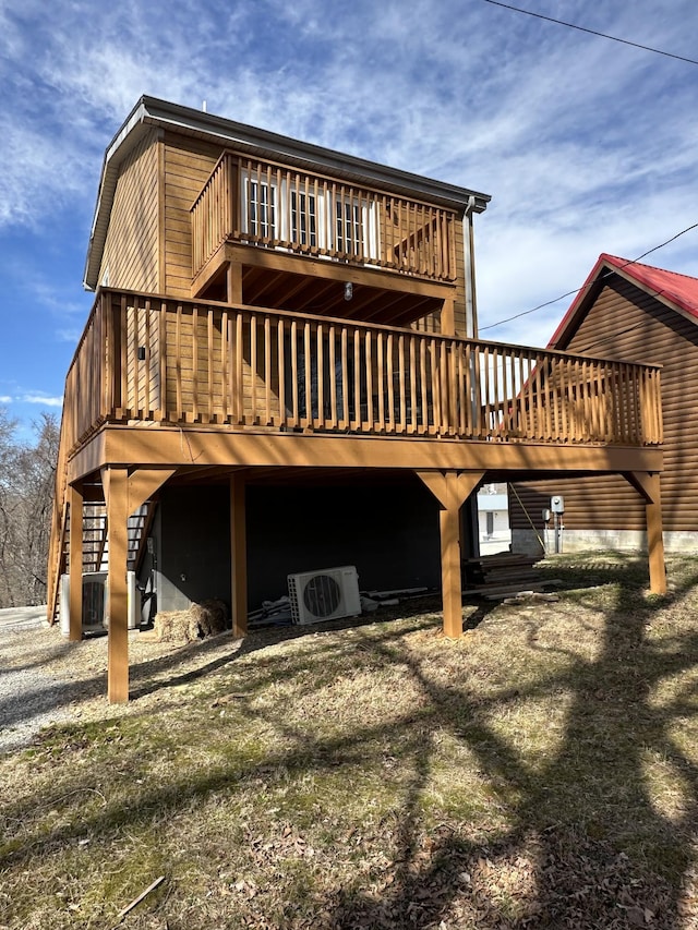 back of property with ac unit, stairway, and a carport