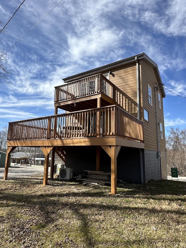 rear view of property with ac unit, a yard, and a wooden deck