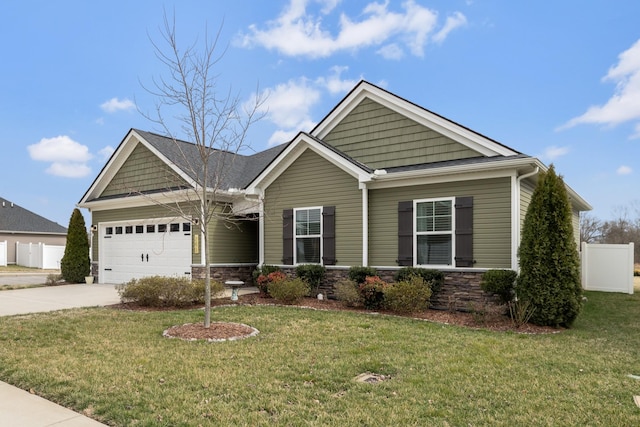 craftsman-style house with stone siding, driveway, an attached garage, and a front yard