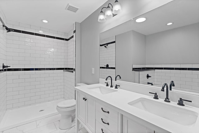 bathroom featuring a sink, visible vents, toilet, and a shower stall