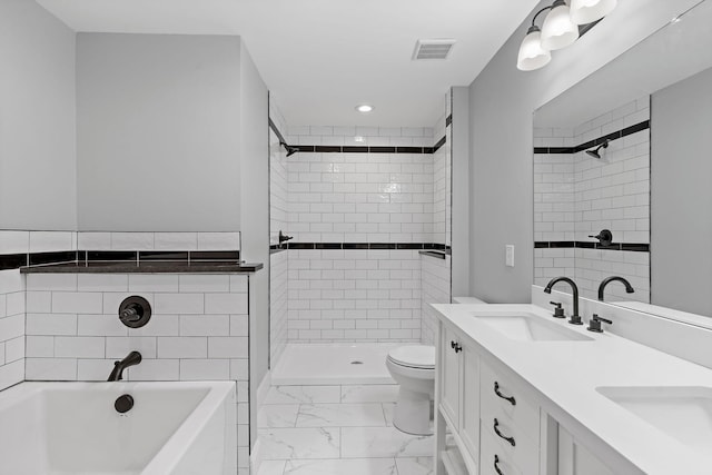 bathroom featuring a stall shower, a bath, marble finish floor, and a sink