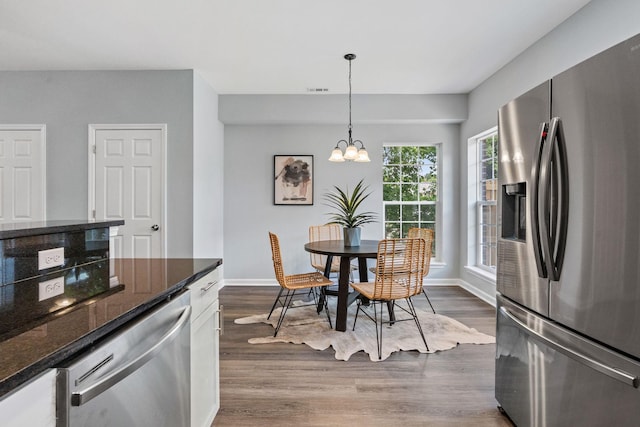 dining room with visible vents, a notable chandelier, dark wood-style floors, and baseboards