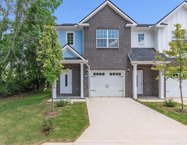 traditional-style house with board and batten siding, a front lawn, brick siding, and driveway