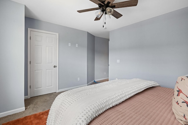 carpeted bedroom featuring baseboards and ceiling fan