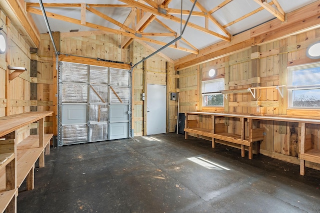 garage featuring a workshop area and wooden walls