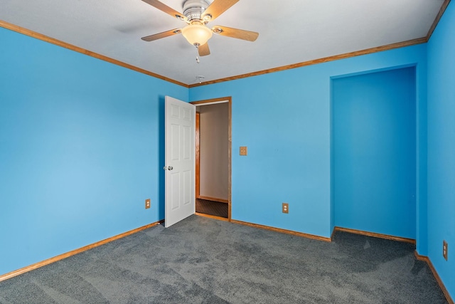 carpeted empty room featuring baseboards, ceiling fan, and crown molding