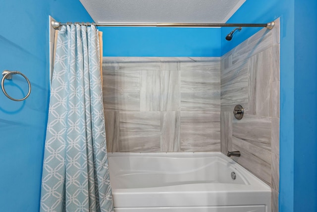 full bath featuring shower / bath combo with shower curtain and a textured ceiling