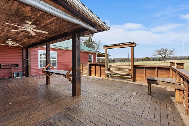 wooden terrace with a ceiling fan and fence