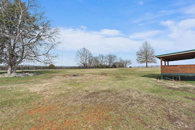 view of yard with a rural view and fence