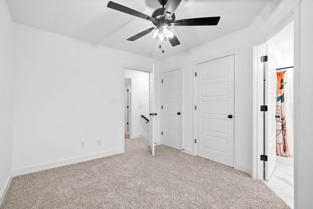 unfurnished bedroom featuring carpet flooring, a ceiling fan, and baseboards