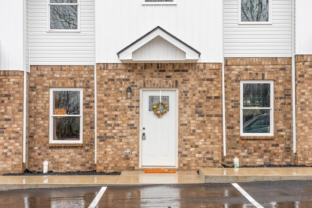 doorway to property with uncovered parking