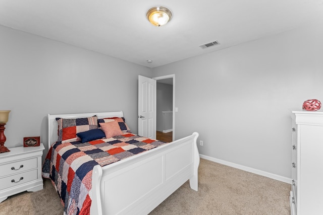 bedroom with visible vents, carpet flooring, and baseboards