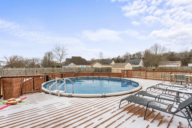 view of pool featuring a fenced backyard, a fenced in pool, outdoor dining area, and a deck