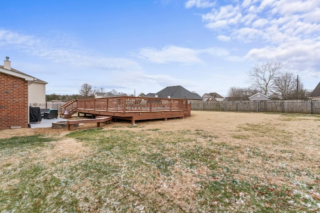 view of yard featuring a wooden deck, a fenced backyard, and a patio area