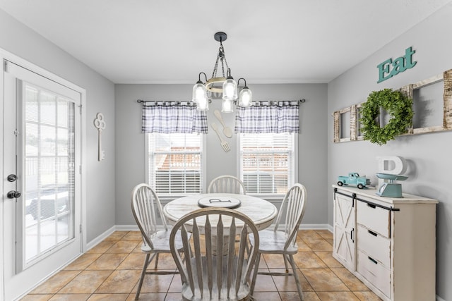 dining room featuring light tile patterned floors, french doors, baseboards, and a chandelier