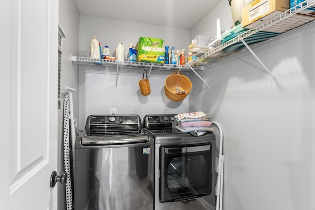 clothes washing area featuring independent washer and dryer and laundry area