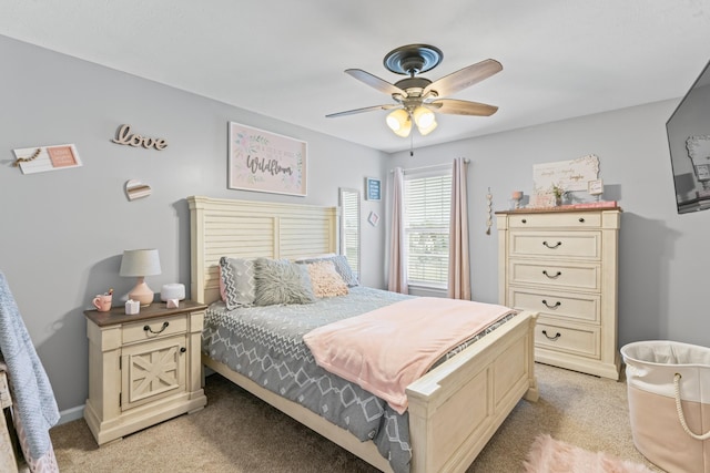 bedroom featuring baseboards, light carpet, and ceiling fan