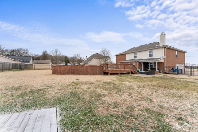 view of yard with a fenced backyard and a wooden deck