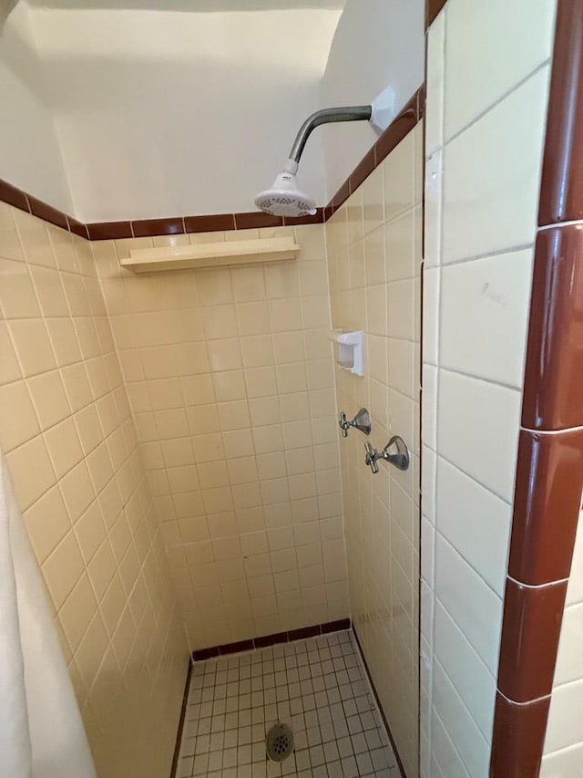 full bath with a shower stall and tile patterned flooring