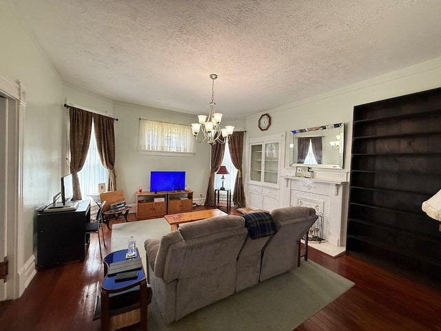 living area with an inviting chandelier, wood finished floors, and a textured ceiling