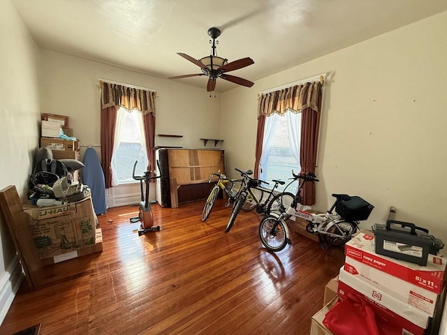 interior space with a ceiling fan and hardwood / wood-style flooring