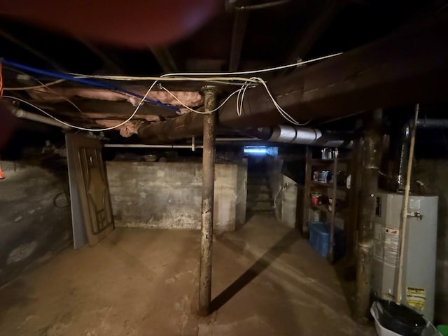 unfinished basement featuring gas water heater