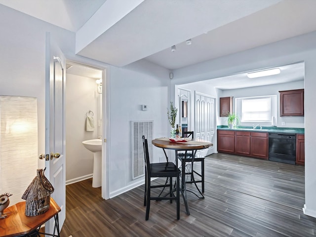 dining room with visible vents, baseboards, and dark wood finished floors