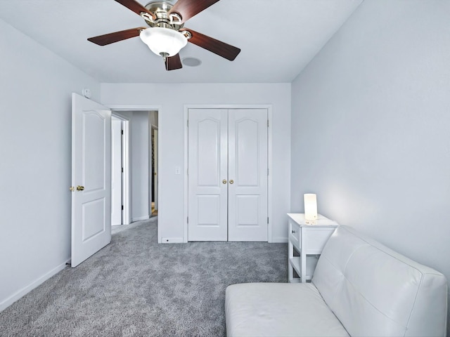 sitting room with baseboards, carpet floors, and ceiling fan