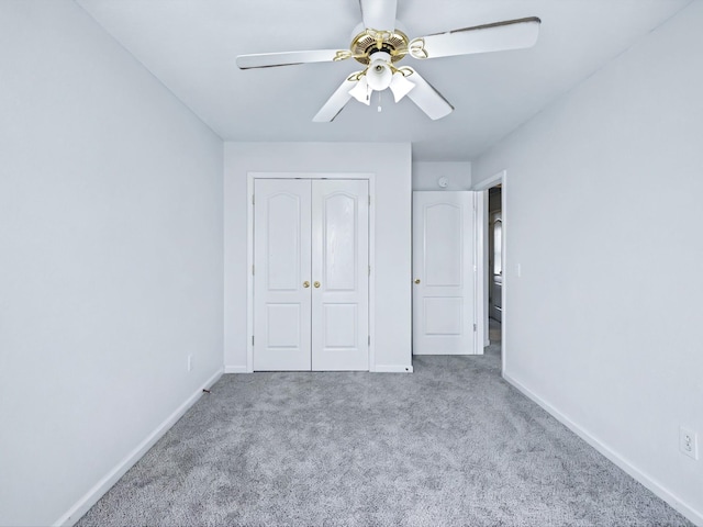 unfurnished bedroom with baseboards, carpet floors, a closet, and ceiling fan