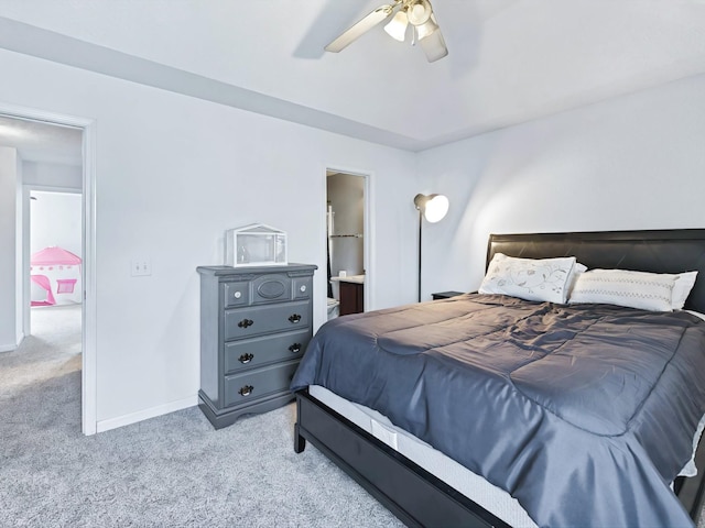 bedroom with connected bathroom, baseboards, light colored carpet, and ceiling fan