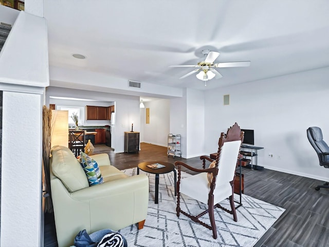 living area with visible vents, baseboards, and dark wood-type flooring