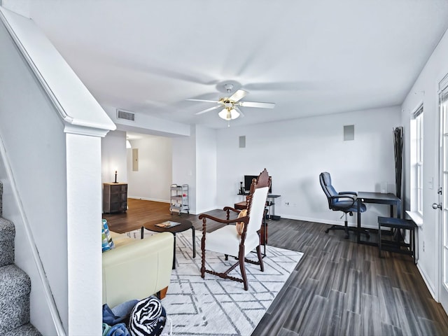 living room featuring dark wood finished floors, visible vents, a ceiling fan, and baseboards