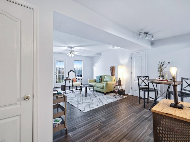 living room featuring ceiling fan, baseboards, dark wood finished floors, and rail lighting