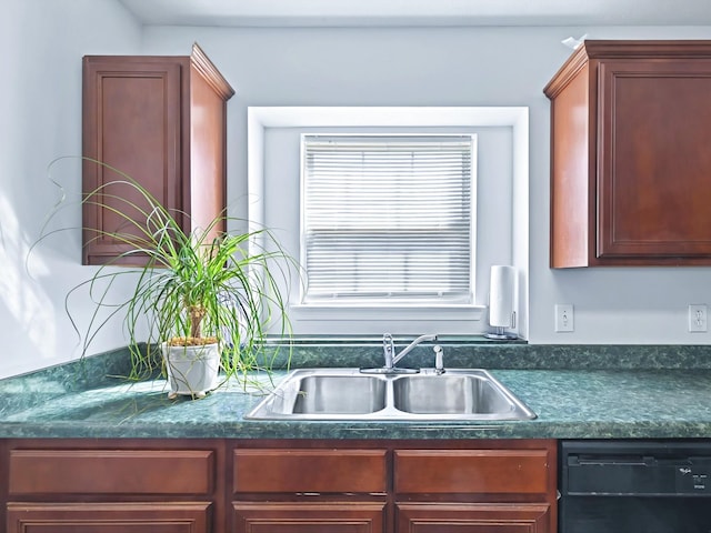 kitchen featuring dark countertops, reddish brown cabinets, black dishwasher, and a sink