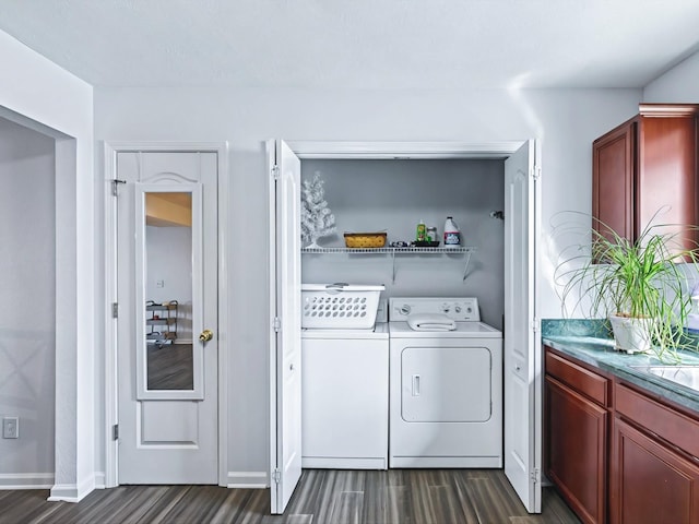 laundry room featuring washer and dryer, laundry area, dark wood finished floors, and baseboards