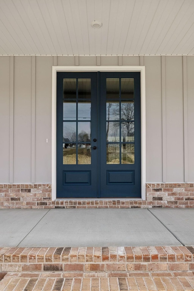 doorway to property with french doors and brick siding