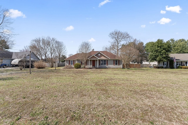 ranch-style house with a chimney, a front yard, and fence