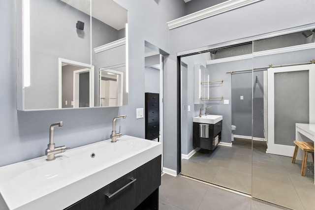 bathroom with toilet, tile patterned flooring, baseboards, a towering ceiling, and vanity