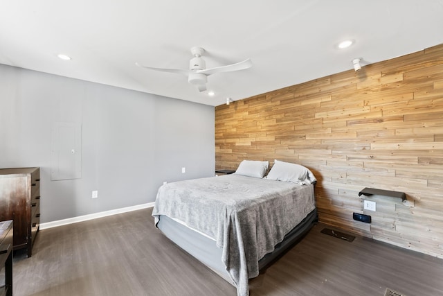 bedroom with a ceiling fan, wood finished floors, recessed lighting, wooden walls, and baseboards