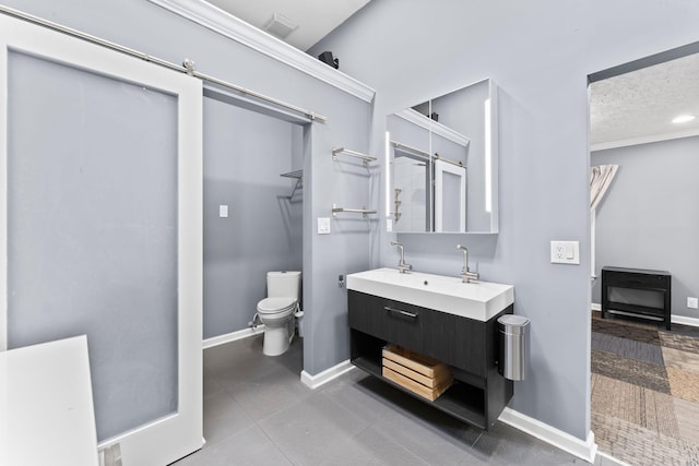 full bathroom with vanity, toilet, baseboards, and a textured ceiling